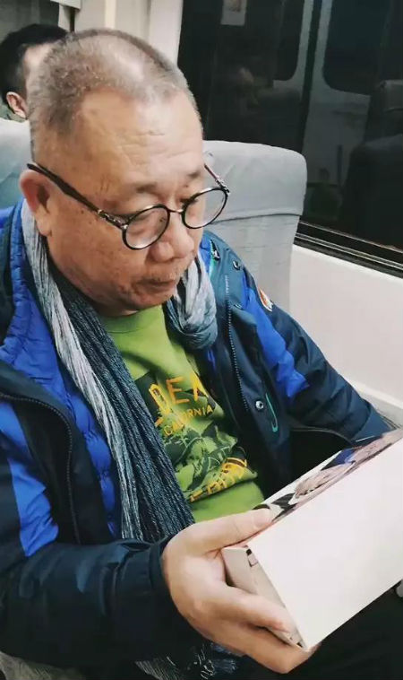 乘客正在翻看《春天的画卷》系列连环画