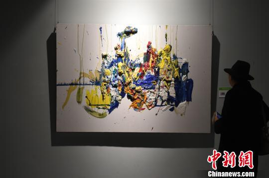 图为市民认真欣赏李华的画作。　周毅　摄